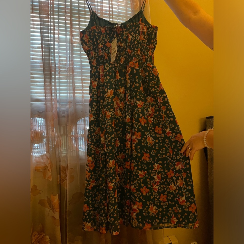 This dress from Patrons of Peace never worn a size small with green pink colors.